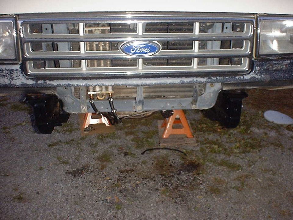 Front grille and axle of a 1988 Ford Bronco on jack stands