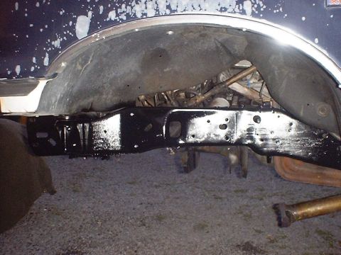 1988 Ford Bronco - Close-up view of the underside of a vehicle, focusing on the frame and suspension components.