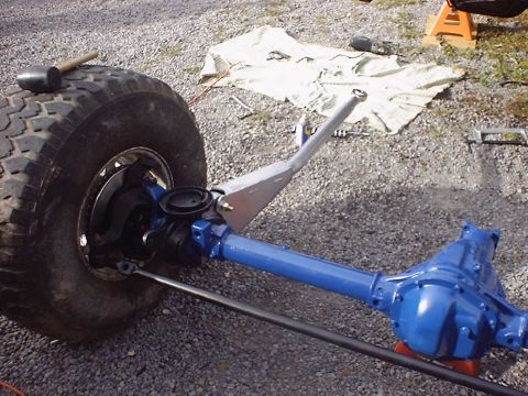 1988 Ford Bronco - A close-up view of a vehicle's front axle assembly, showing the differential and part of a tire.