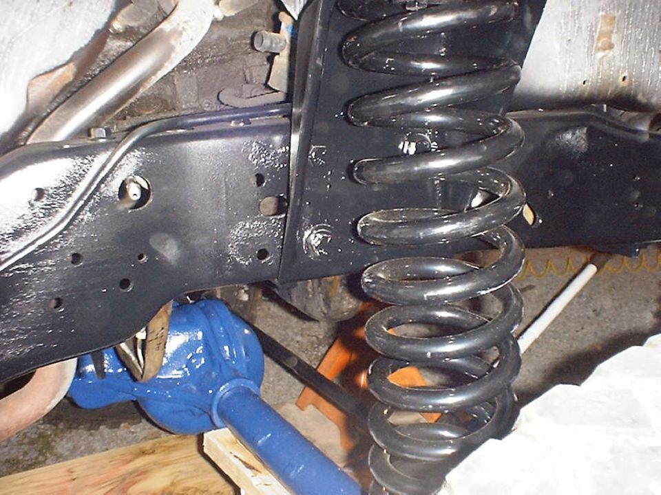 close-up of vehicle's front axle and coil spring assembly