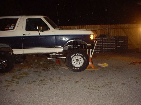 1988 Ford Bronco - This lifted Ford Bronco is undergoing maintenance, with its front end elevated on jack stands.