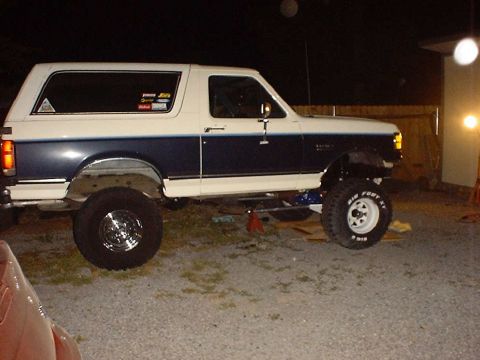 1988 Ford Bronco - This lifted 1988 Ford Bronco has a two-tone paint scheme and custom stickers on the rear window.