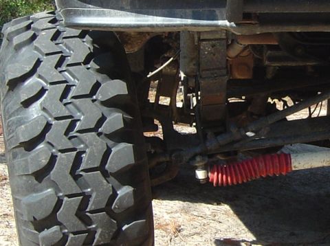 1993 Ford Bronco - Detail shot of off-road tire and suspension parts.
