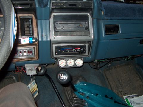 1986 Ford Bronco - The interior of a 1986 Ford Bronco shows aftermarket gauges installed below the radio.