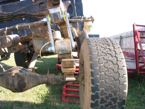 1986 Ford F-150 - Close-up of a truck's rear suspension and differential, supported by red jack stands.