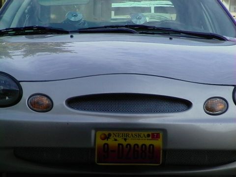 1999 Ford Taurus - Front view of a silver 1999 Ford Taurus, its distinctive grille and headlights.