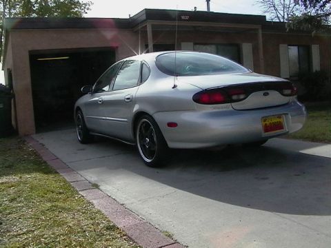 1999 Ford Taurus - Silver 1999 Ford Taurus parked in front of a house with garage.