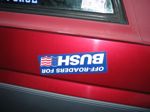 1995 Ford Bronco - A bumper sticker is affixed to the side of a red vehicle.