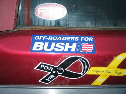 1995 Ford Bronco - Rear of a red vehicle displaying political and support our troops bumper stickers.