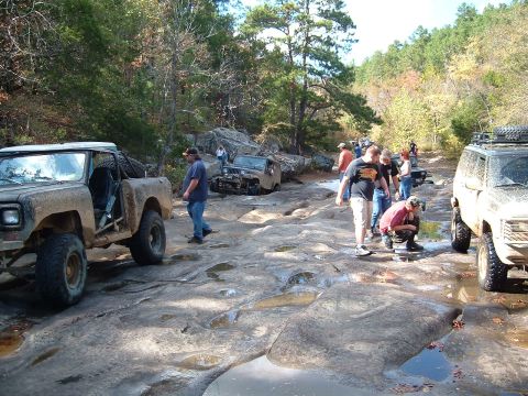 1986 Ford Bronco - Off-road vehicles traversing a challenging rocky path during an outing.