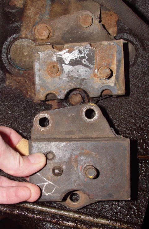1969 Ford Fairlane - Close-up view of heavily rusted metal brackets, showing bolts and mounting points.