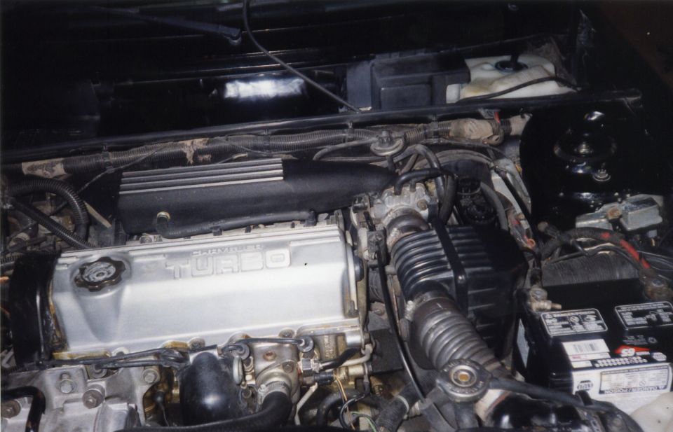 Here is a picture of the engine bay before I had a new head gasket and a rare 89 CSX VNT Shelby valve cover installed