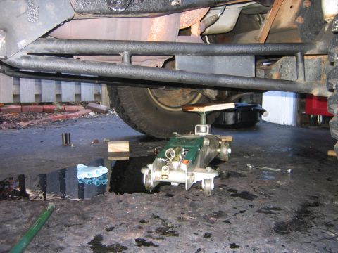 1995 Ford Bronco - Now that the engine mounts are un-bolted I can jack up the engine, make sure to use a piece of wood between where ever it is you jack it up…