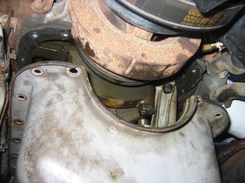 1995 Ford Bronco - With the engine jacked up you can un-bolt the oil pan, and the oil pump. The oil pump has two bolts in it, one of them visible in this pict…