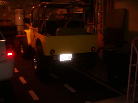 1978 Ford Bronco - The rear of a yellow Jeep CJ is visible, a roll cage and a license plate.