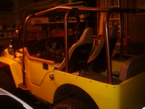 1978 Ford Bronco - This yellow jeep has a roll cage and bucket seats, with a partial view of the interior.