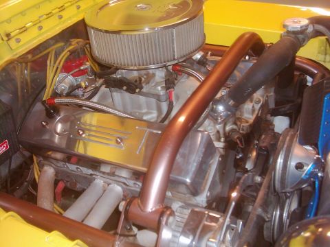 1978 Ford Bronco - Close-up view of a modified engine bay with custom copper piping and chrome accents.
