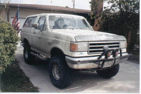 1990 Ford Bronco - This 1990 Ford Bronco is covered in mud, suggesting recent off-road use.