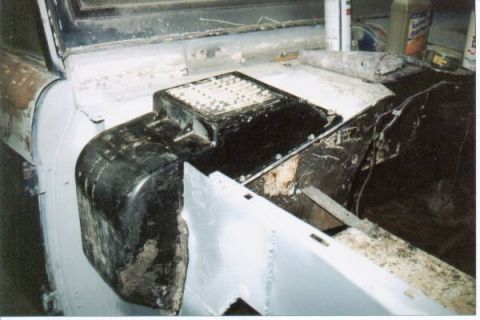1966 Ford Bronco - Interior of a stripped vehicle under restoration, showing a bare light-blue painted floor and firewall with the black transmission tunnel a…
