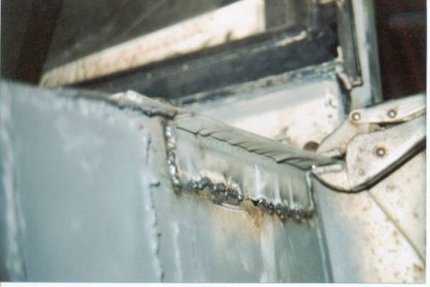 1966 Ford Bronco - Close-up of welding work on a vehicle's metal structure, showing signs of rust.