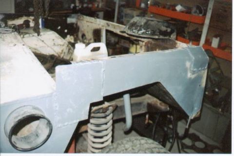 1966 Ford Bronco - Bodywork in progress on a 1966 Ford Bronco, focusing on the fender and suspension components.
