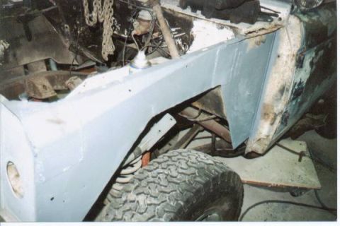 1966 Ford Bronco - This vehicle is undergoing body repairs, with a focus on the front fender and wheel well area.