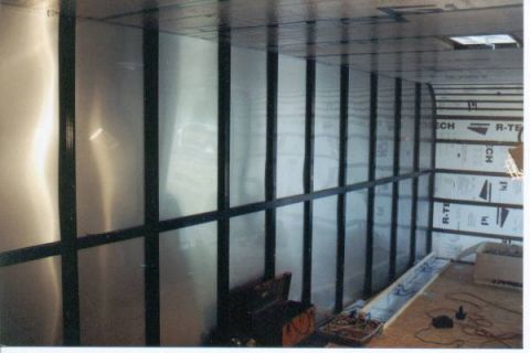 1990 Ford Bronco - The interior of a trailer shows construction with insulation panels and metal walls.