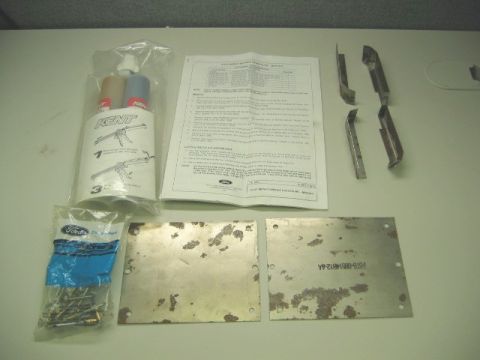 1986 Ford Bronco - A repair kit laid out on a gray table, including a KENT-branded dual-cartridge adhesive applicator in a bag, a Ford instruction sheet, seve…
