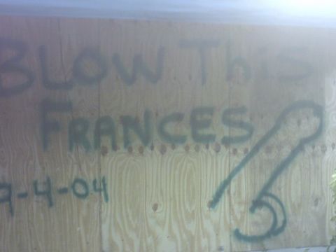 1992 Ford Bronco - Graffiti spray-painted on plywood includes a date of 9-4-04 and a crude drawing.