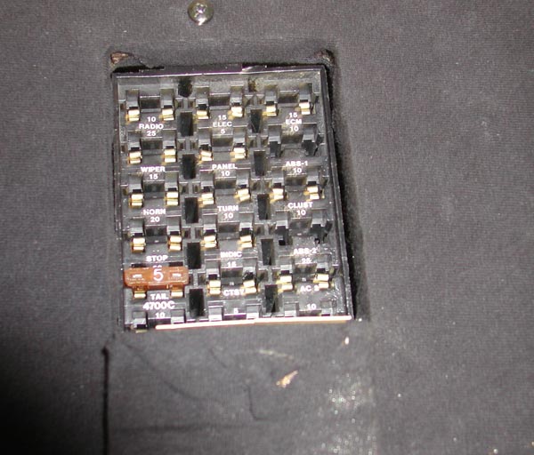 Interior fuse panel with labeled circuits and a single tan 5-amp fuse installed