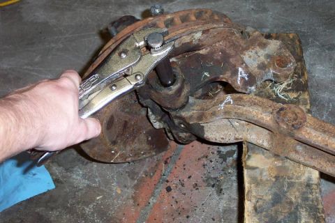 1968 Ford F-100 - Stop 7--Use a hardened drift of some sort (this is a Chevy axle pin) and a heavy dead-blow hammer to drive the pin out. It took over an hou…