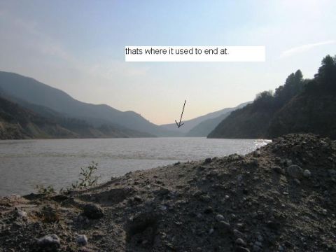 1985 Ford Bronco - A scenic view of a lake and mountains, with an arrow pointing to a distant point on the water.