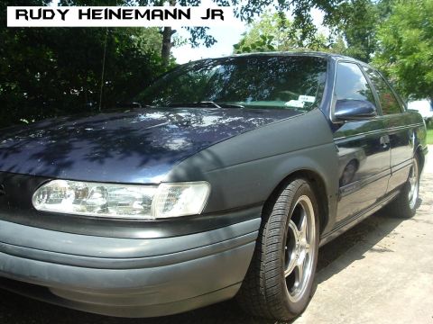 1993 Ford Taurus - This sedan has a mismatched front fender and appears to be from the early 1990s.