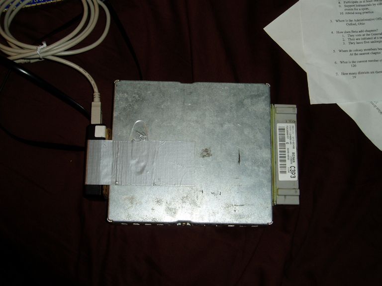 Engine control module with duct-taped case and plug-in tuner, labeled C3P3