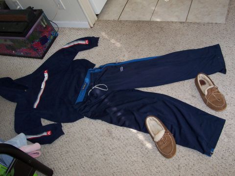 1993 Ford Probe - A sweatsuit and slippers are arranged on the floor next to a fish tank.