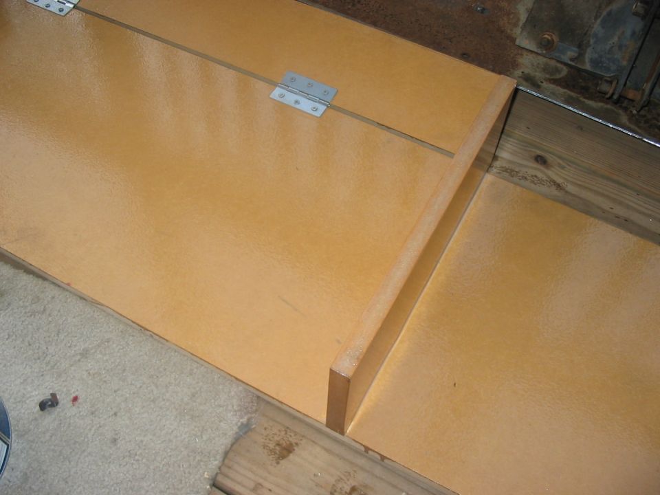 Interior storage compartment with wooden panels and metal hinges