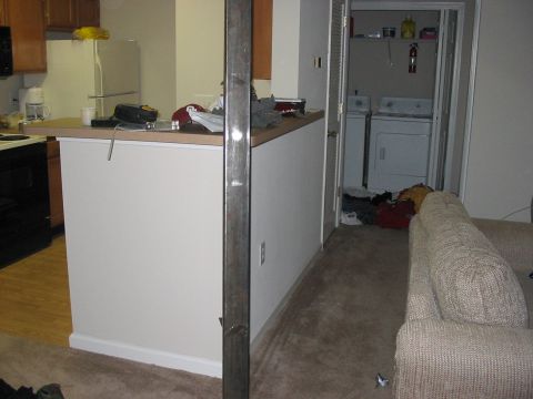 1988 Ford Bronco - The photo shows a domestic scene with a kitchen area, laundry appliances, and living room furniture.