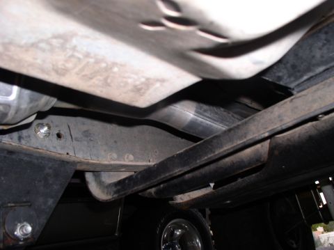 1990 Ford Bronco - Close-up of the undercarriage, focusing on the exhaust system components.