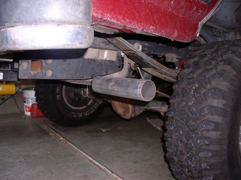 1990 Ford Bronco - Close-up view of the rear axle and exhaust system of a vehicle.