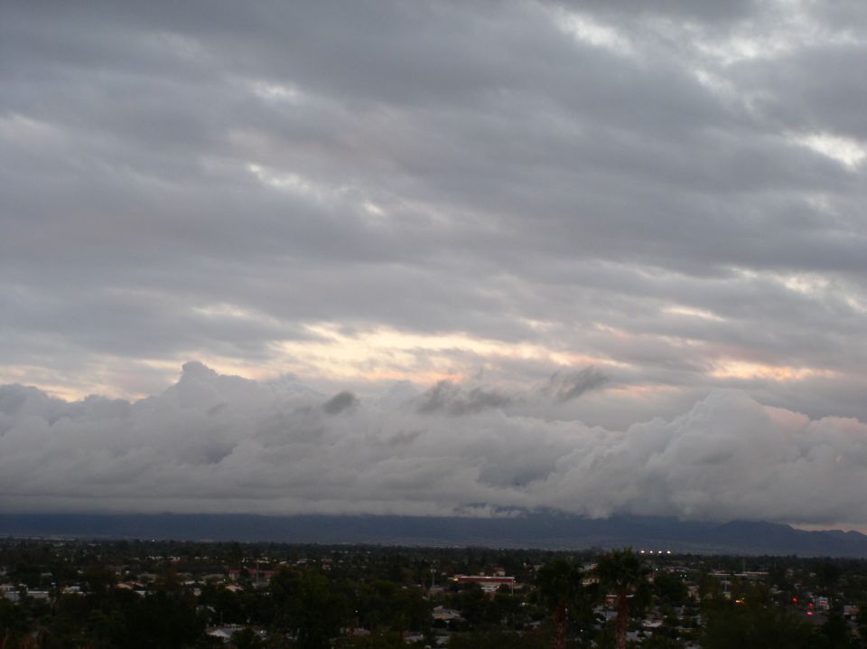 Stormy sky over a city with Supermotors logo