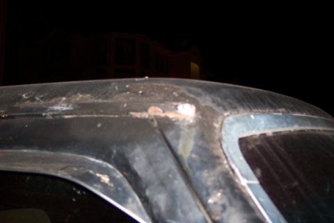 1986 Ford Bronco - The image shows the top of a vehicle with significant rust and damage, along with a watermark from Supermotors.net.