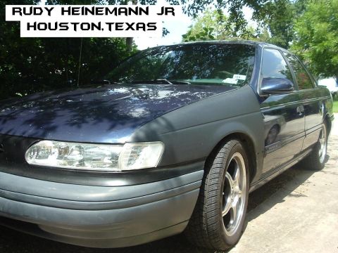 1993 Ford Taurus - This 1993 Ford Taurus is shown from the front three-quarter angle, highlighting its dark blue exterior.