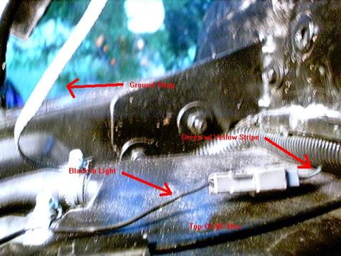 1979 Ford Bronco - Close-up view of engine bay wiring with labels indicating ground strap, black to light, green w/ yellow stripe, and top of air box.