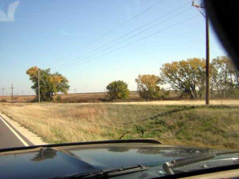 1995 Ford Bronco - Driving through a rural area with autumn foliage visible on the trees.