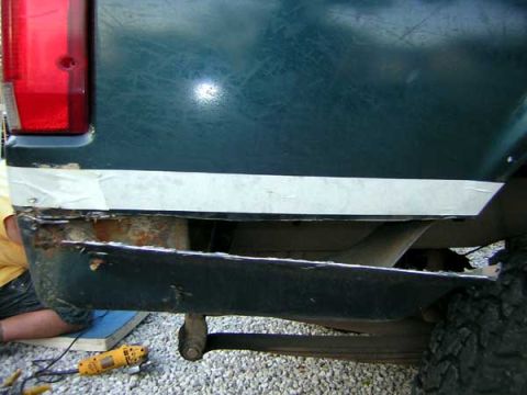 1995 Ford Bronco - Repairing the rusted rear bumper of a 1995 Ford Bronco with a grinder.