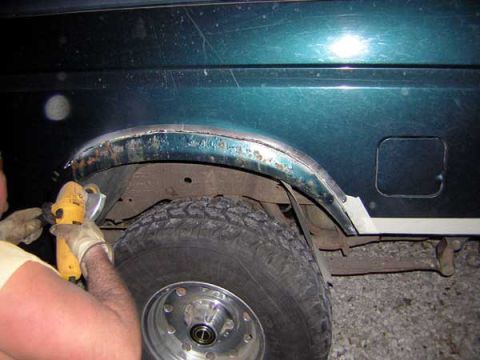 1995 Ford Bronco - Grinding away rust on the wheel arch of a 1995 Ford Bronco.