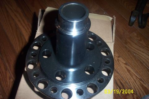 1979 Ford F-150 - A black differential carrier with a circular pattern of bolt holes is shown on a cardboard box.