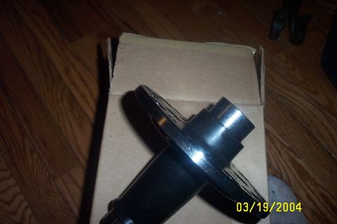 1979 Ford F-150 - A black metal part is shown, possibly a component for a vehicle, on a wooden floor.