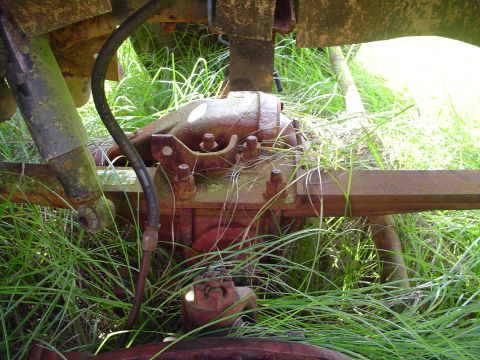 1984 Chevrolet Blazer - This photo shows a close-up view of a vehicle's rear axle assembly, partially obscured by tall grass.