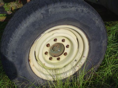 1984 Chevrolet Blazer - Close-up view of a yellow steel wheel and tire, likely from an older vehicle or equipment.